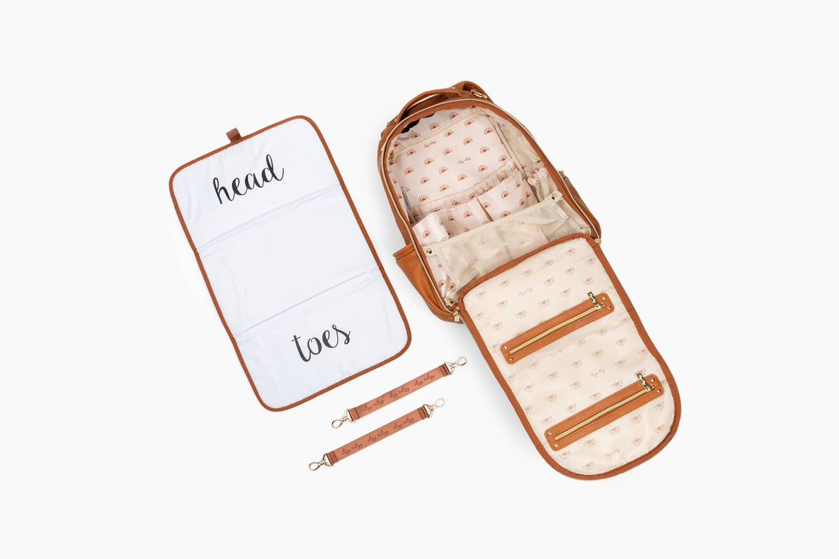 Baby carrier with a white mat labeled 'head' and 'toes' on a white background