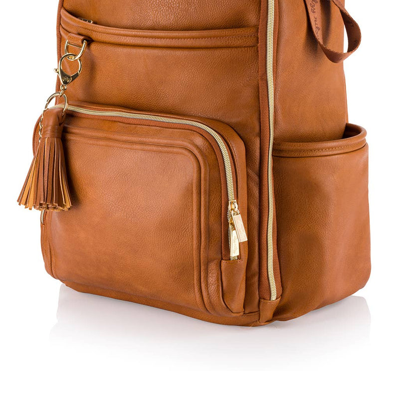 Brown leather backpack with gold zipper and tassel on a white background